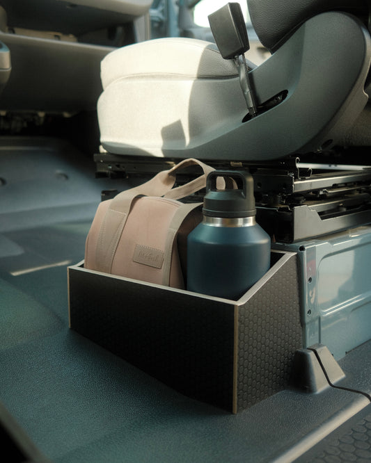 Car cup holder with a beige bag and blue water bottle inside